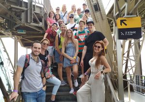 Tour group climbing Eiffel Tower in summer