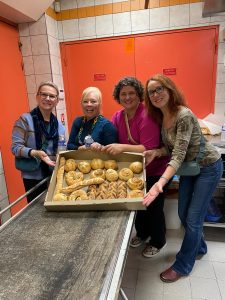 Guests posing with tray of freshly baked bread