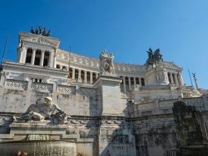 a large stone building with statues on top