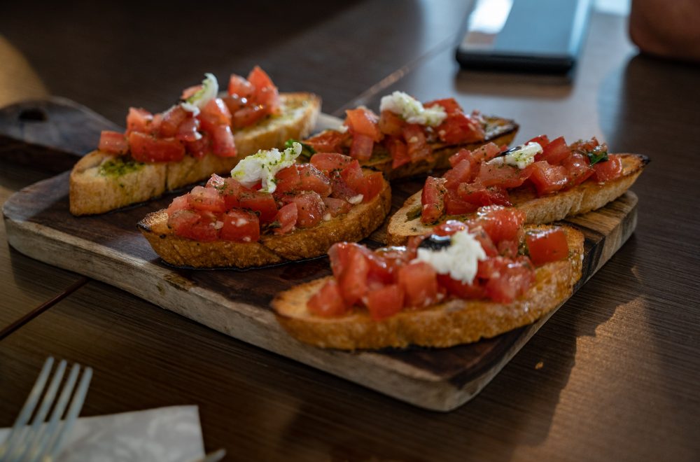 Bruschetta with tomato and mozzella cheese on a serving board San Antonio
