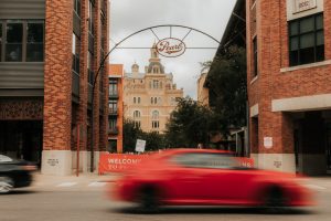 Pearl Arch with red car going by in San Antonios Pearl District