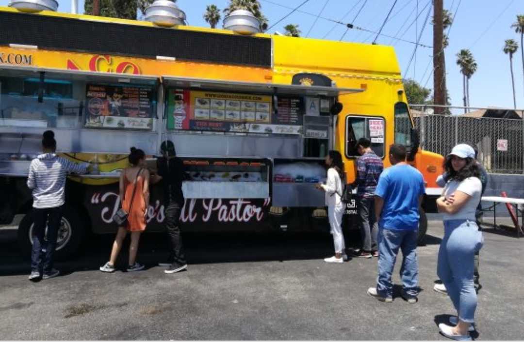 People standing in front of a food truck