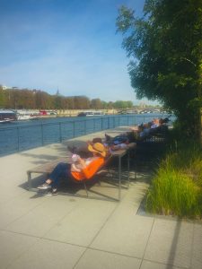 relaxing in chaise lounges next to the Seine in Paris
