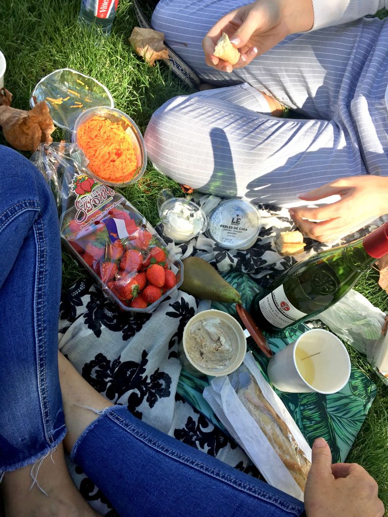 A selection of typically french food items at a picnic in the grass