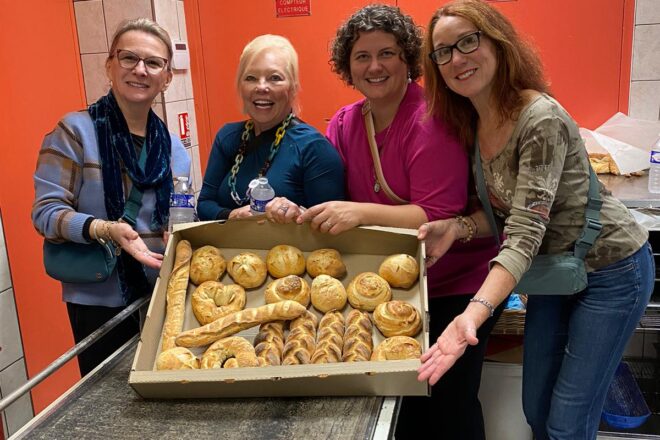 Guest posing with tray of freshly baked bread