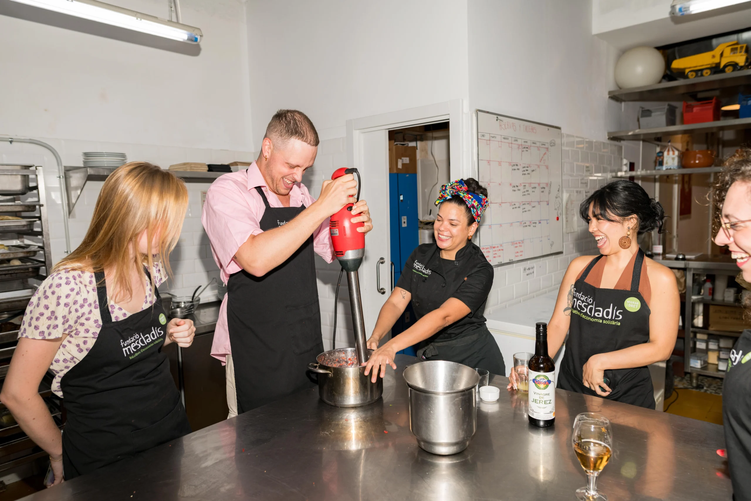 Guests cooking and enjoying in cooking class in Barcelona