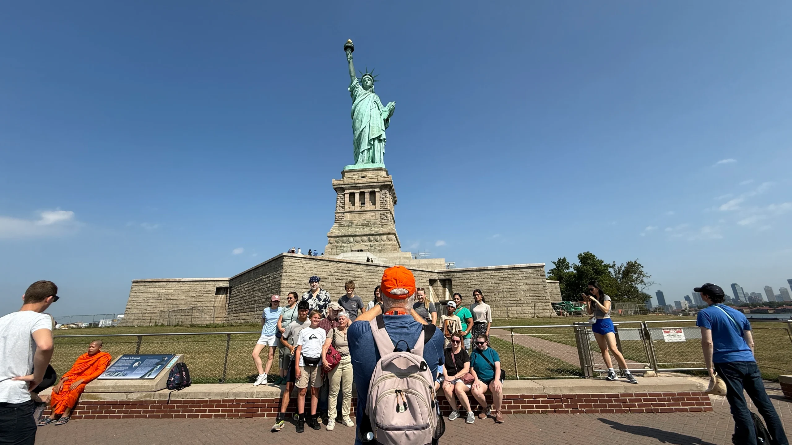 Guide taking photos of guests during Statue of Liberty and Ellis Island guided tour