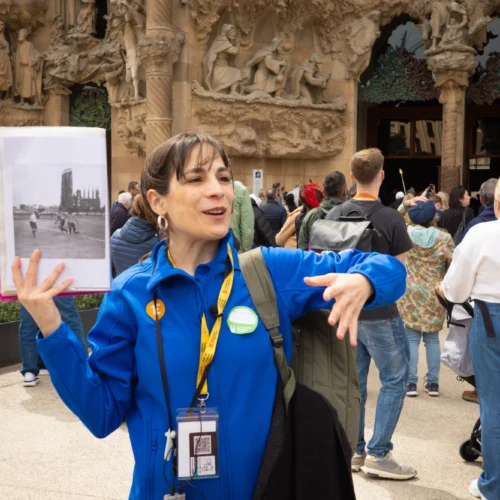 Tour guide showing historic photo on Sagrada Familia tour in Barcelona