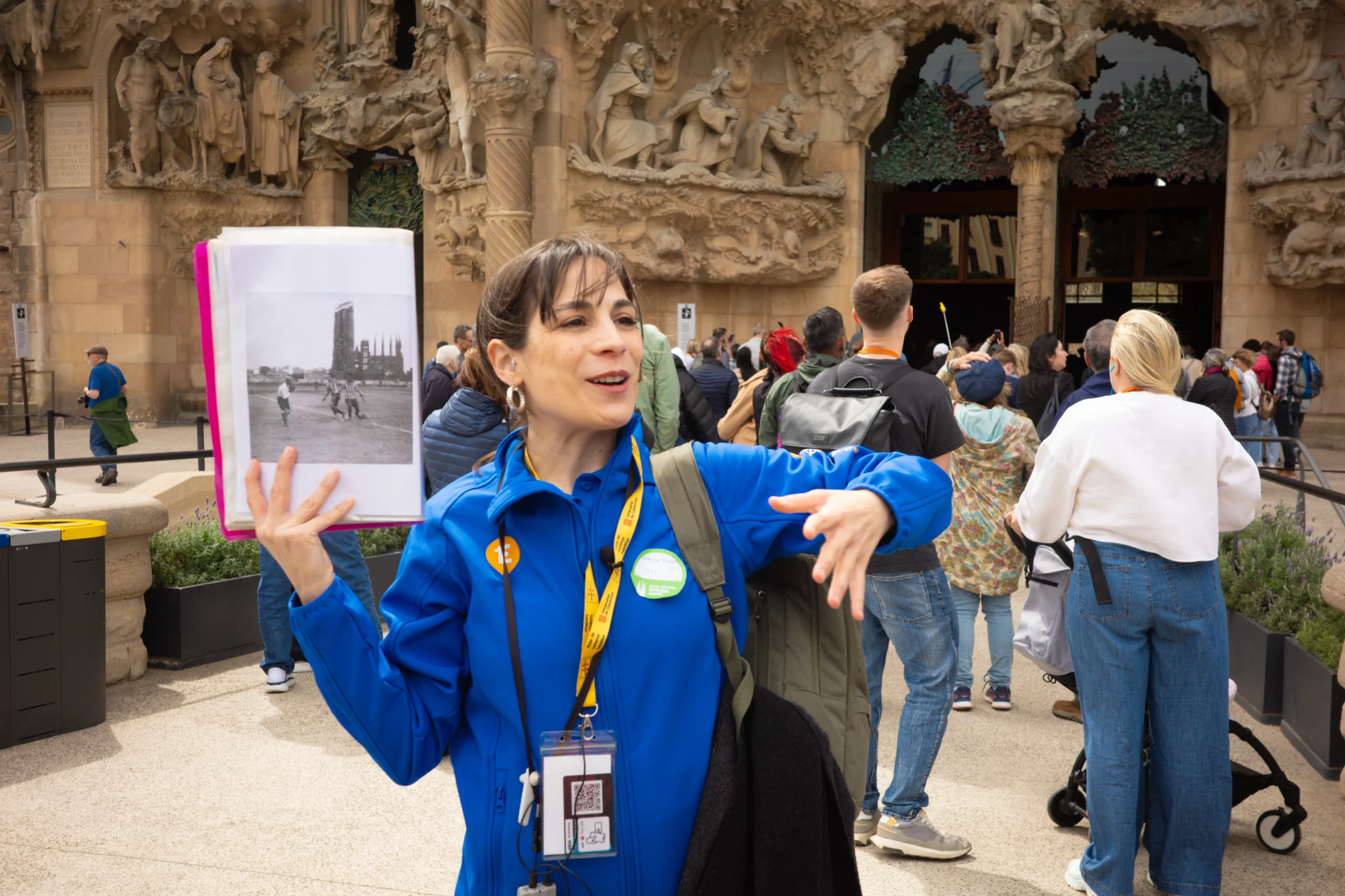 Tour guide showing historic photo on Sagrada Familia tour