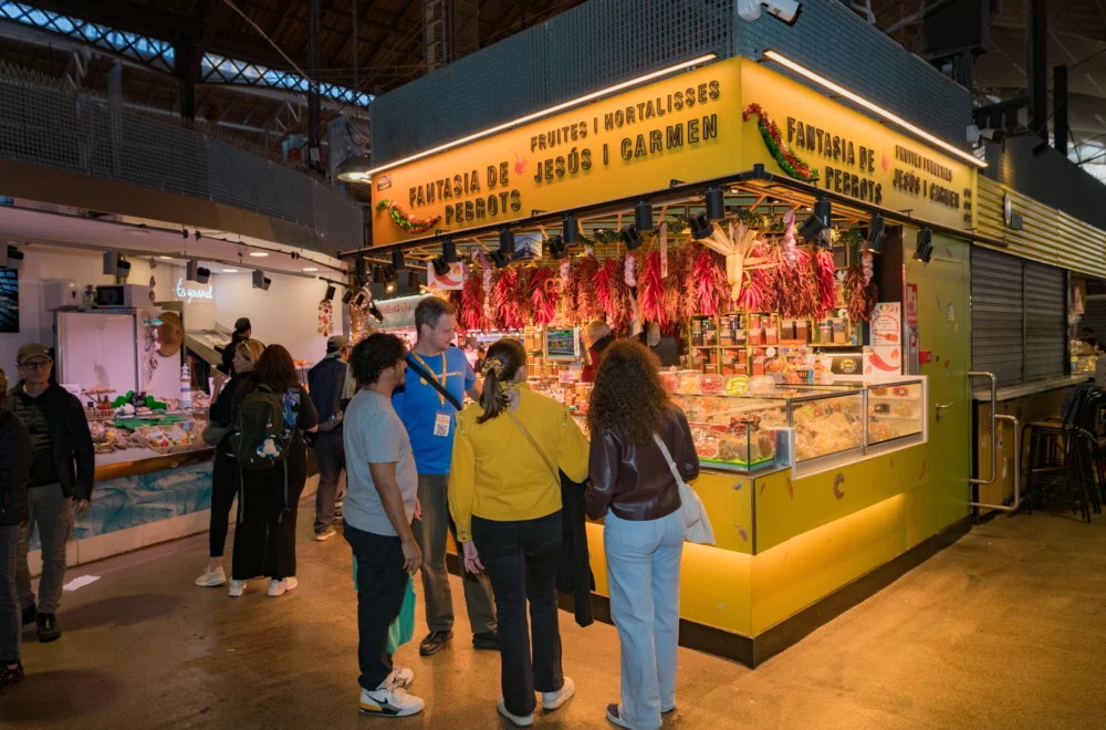Guests and tour guide looking at market stall