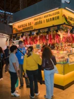 Guests and tour guide looking at market stall