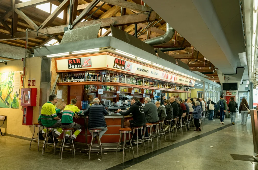 People eating at Bar Joan market stall during Barcelona Markets Tour