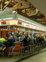 People eating at Bar Joan market stall during Barcelona Markets Tour