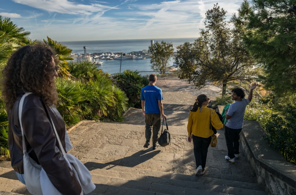 Tour guide and group walking during Montjuic Walking Tour