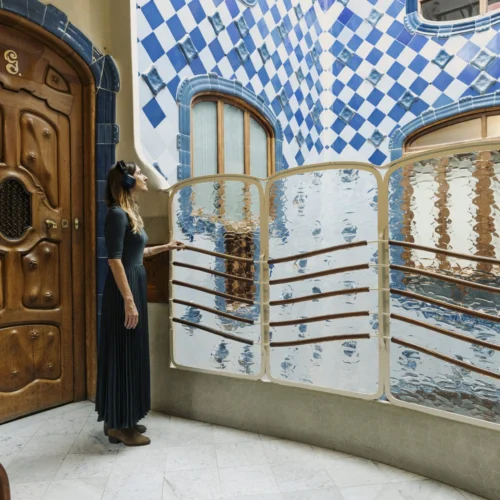 Woman listening to audio guide in Casa Batllo Insider Tour