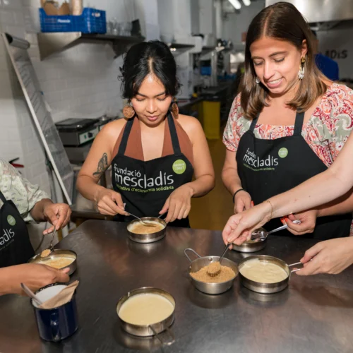 Group cooking dessert during cooking class in Barcelona