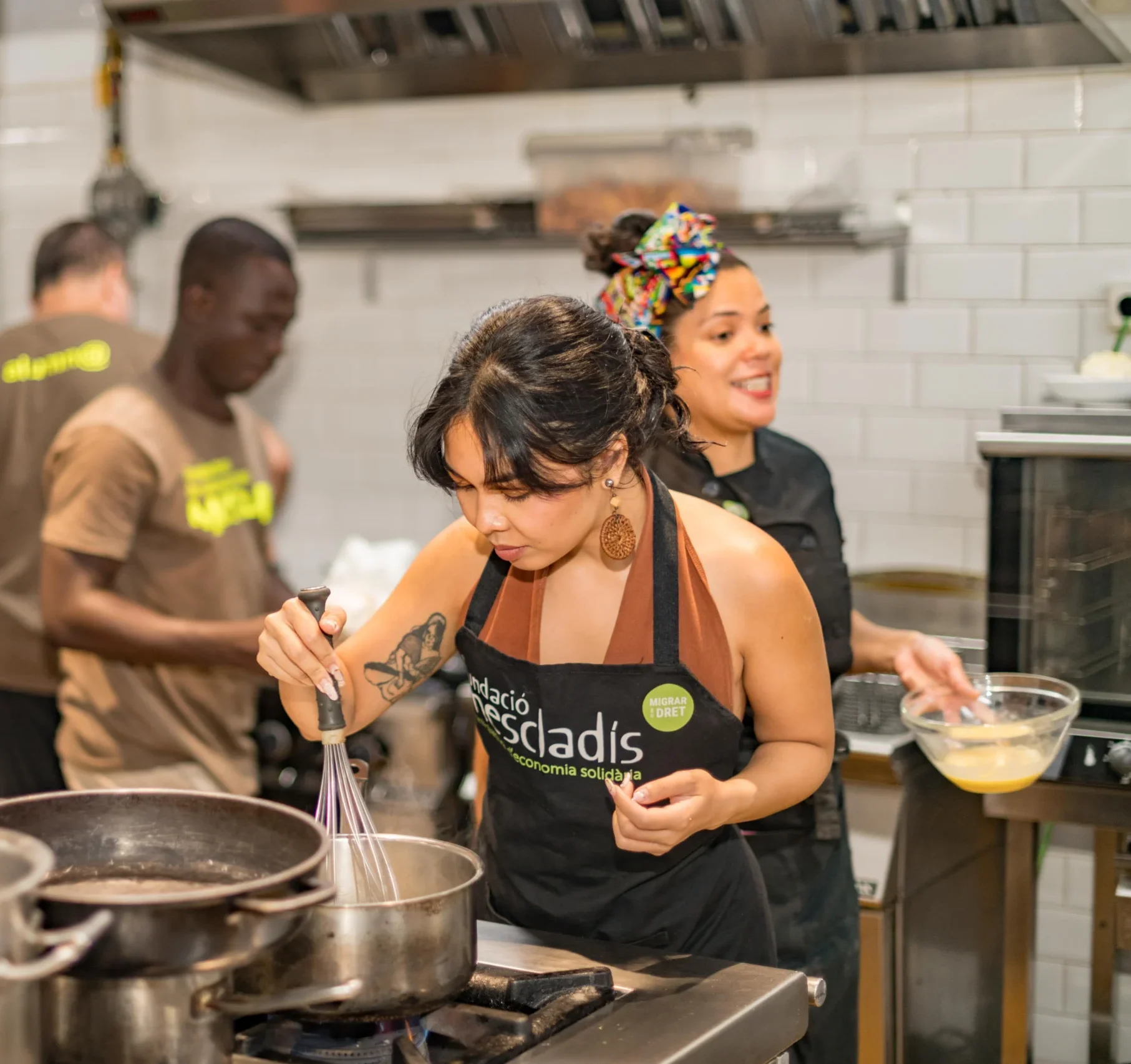 Guest cooking in kitchen during Barcelona cooking class