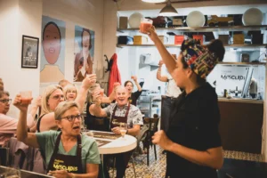 Host cheering group in dining area during cooking class in Barcelona