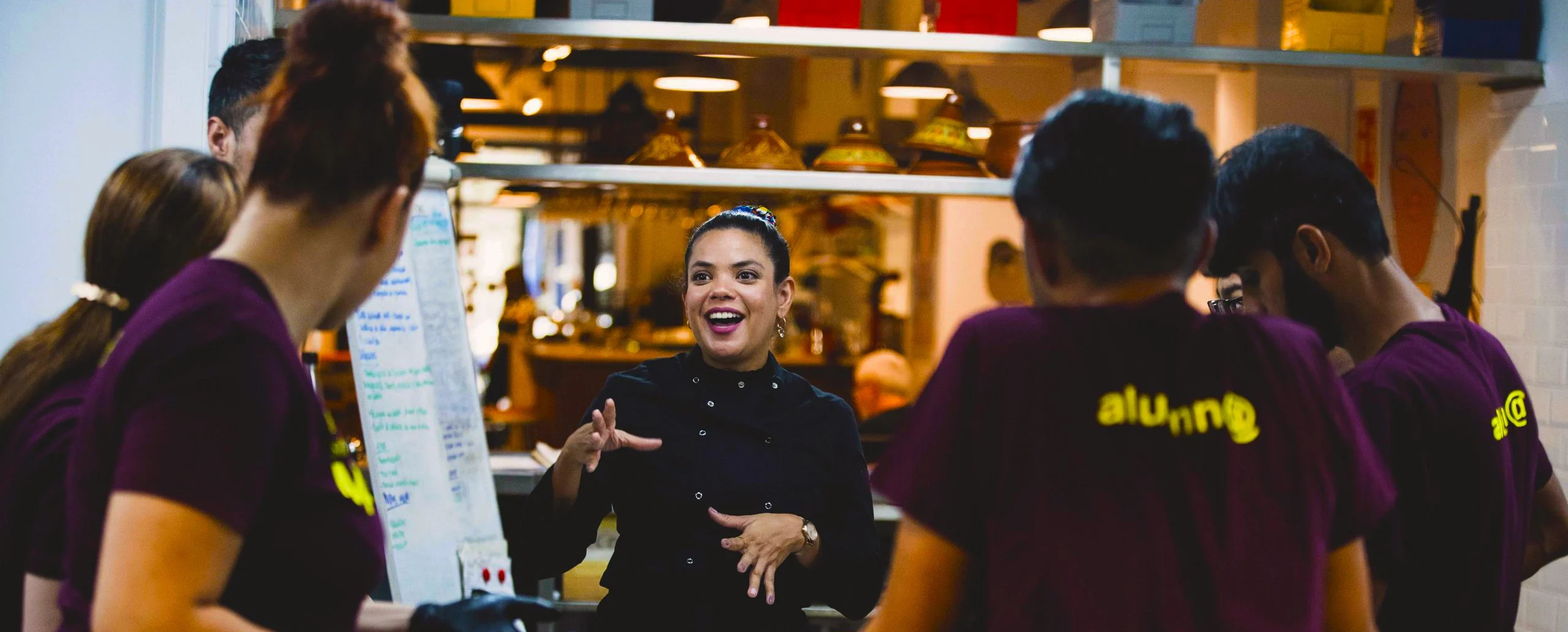Host instructing participants during cooking class in Barcelona