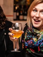 Close up of guests enjoying a glass of wine
