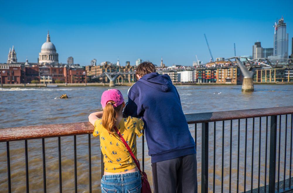 Teenage boy and his sister enjoying view of London, England, from South Bank of River Thames