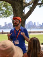 Focused shot of ExperienceFirst tour guide talking to tour group