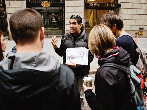 Wall Street tour guide with group