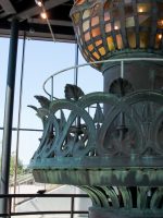 Man taking photo of artifact in Statue of Liberty museum
