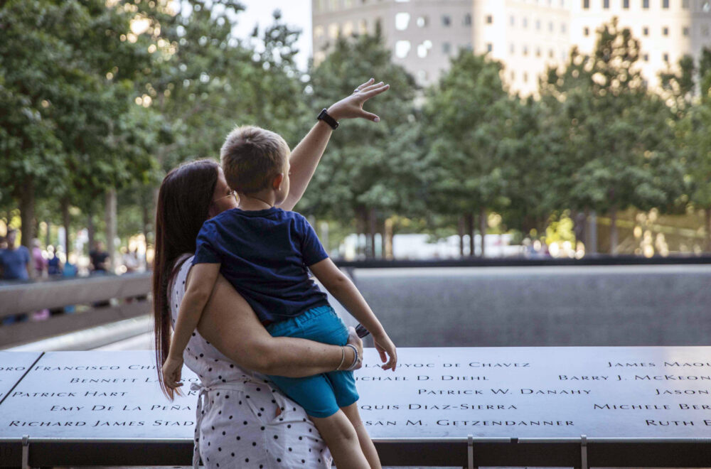 Mother holding child at Ground Zero memorial