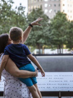 Mother holding child at Ground Zero memorial