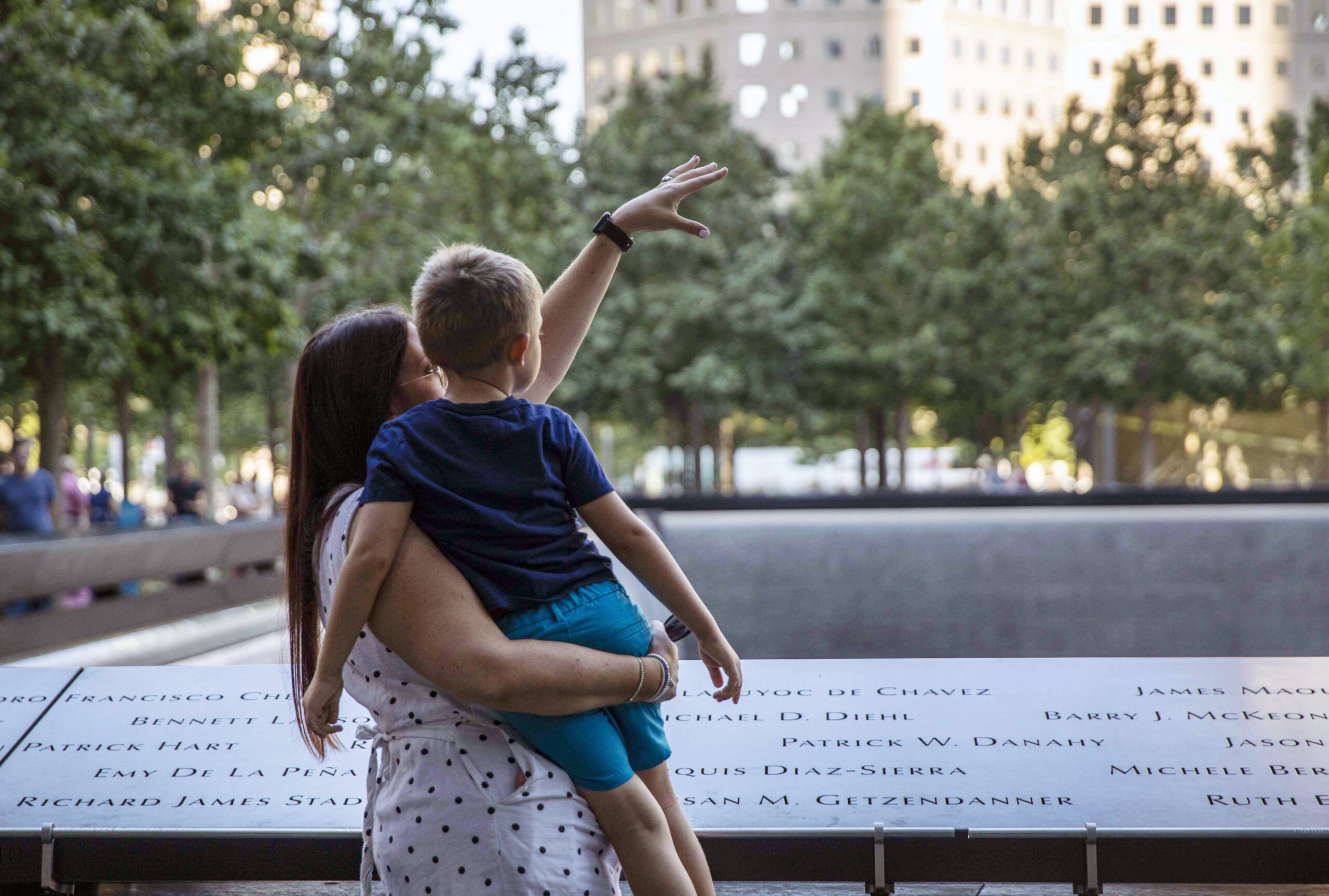 Mother holding child at Ground Zero memorial