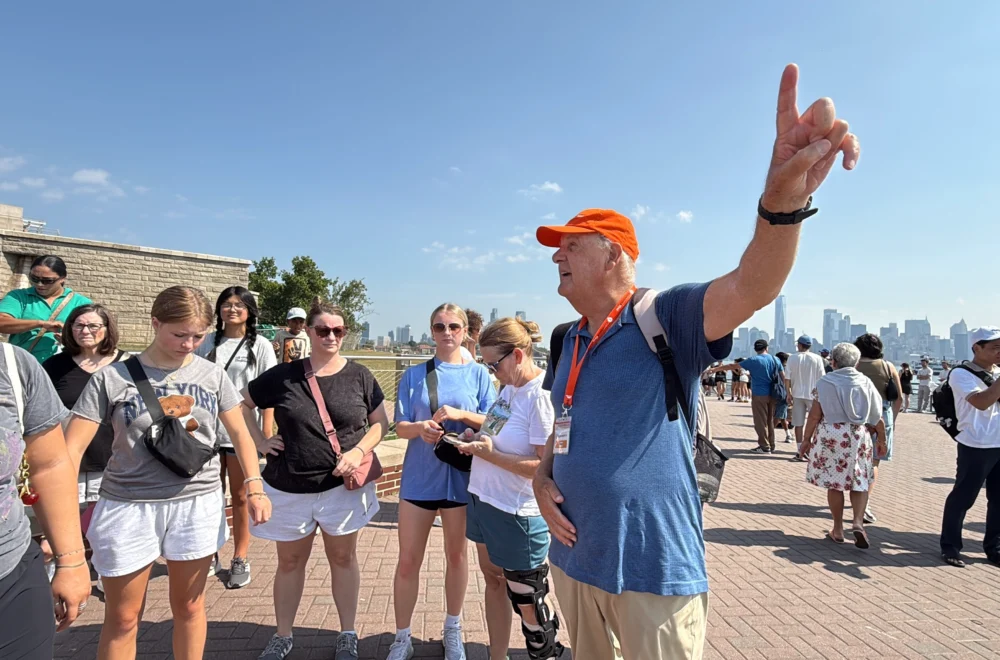 Tour guide directing guests during Statue of Liberty and Ellis Island tour