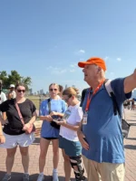 Tour guide directing guests during Statue of Liberty and Ellis Island tour