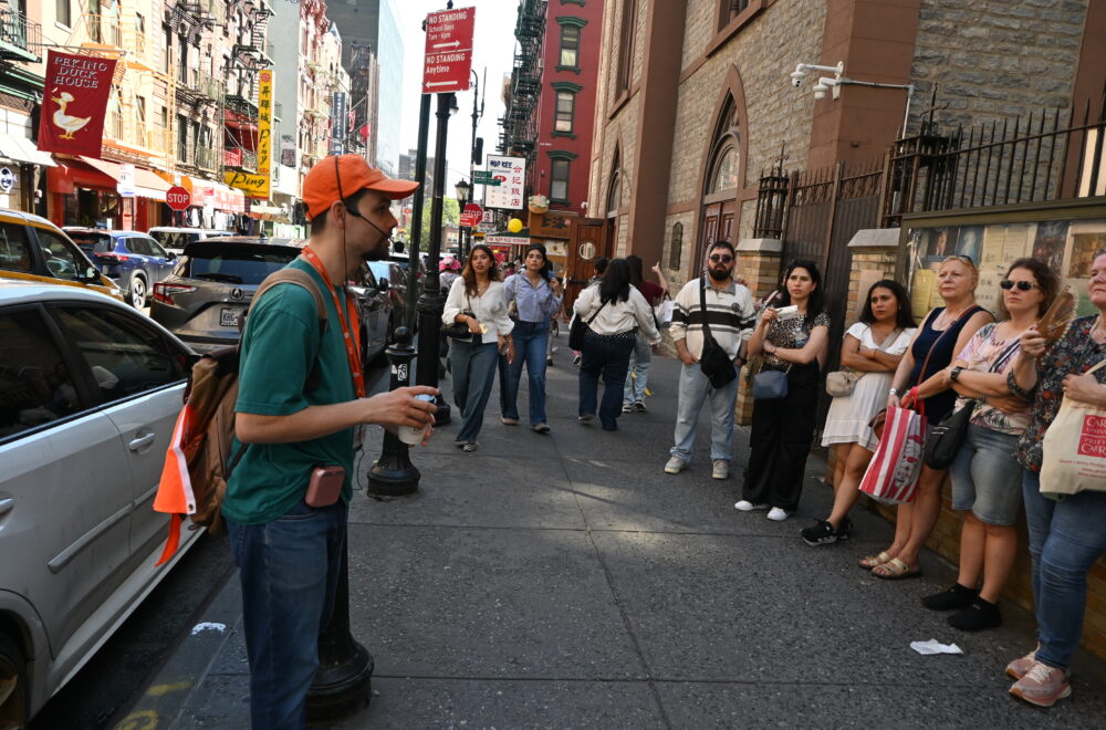Tour guide explaining to guests during Soho, Little Italy and Chinatown tour