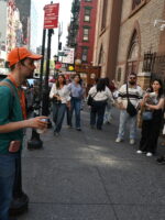 Tour guide explaining to guests during Soho, Little Italy and Chinatown tour