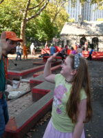 Tour guide high-fiving little girl during tour in New York City