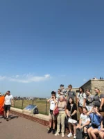 Tour guide taking photo of guests during Statue of Liberty and Ellis Island tour