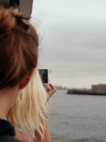 Tourists looking at Statue of Liberty from ferry
