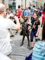 Travelers taking photos with the Fearless Girl Statue in NYC
