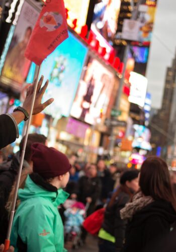Guide leading a Broadway tour through Times Square