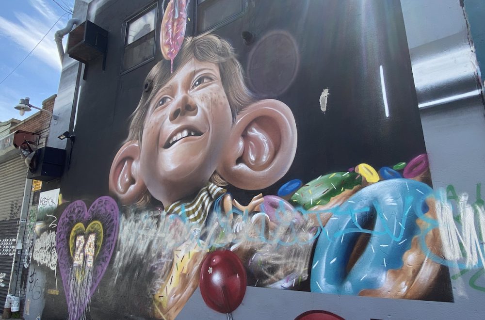 Bushwick graffiti art with mural of boy