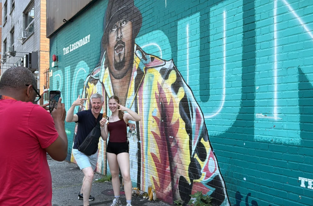 People taking image with mural in Bushwick during Brooklyn Bronx and Queens tour
