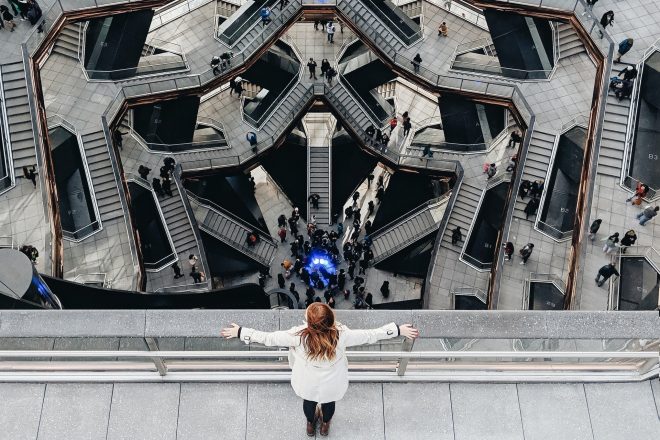 Woman looking at Vessel art installation in NYC