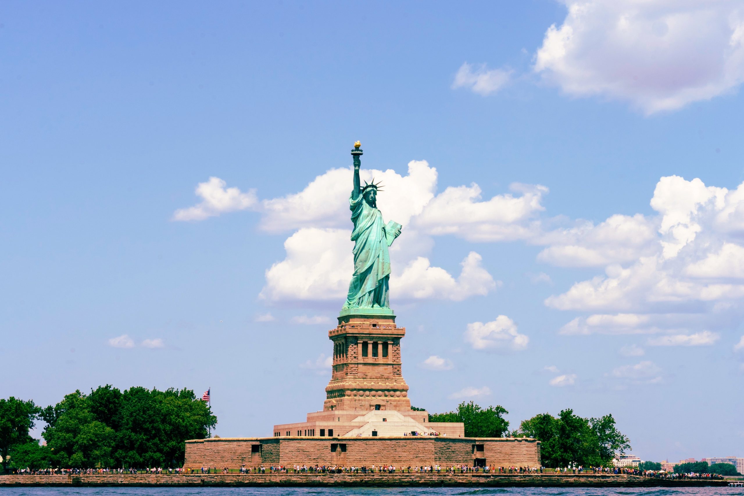 Tourists looking at Statue of Liberty from ferry