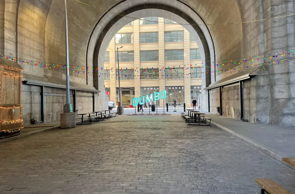 Dumbo lit up sign through archway