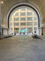 Dumbo lit up sign through archway