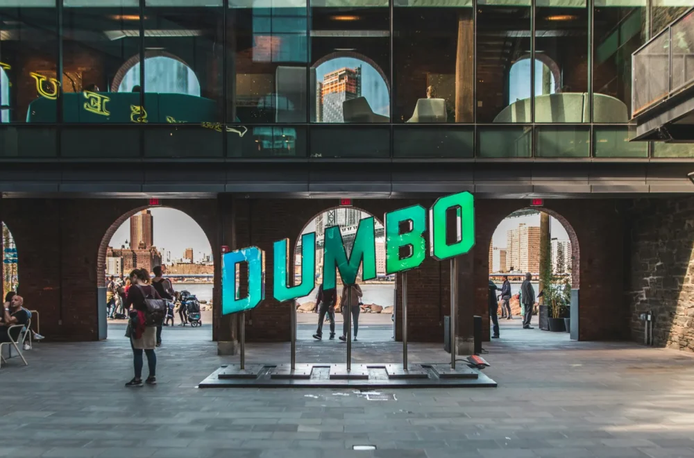 People walking near Dumbo sign in Brooklyn NYC