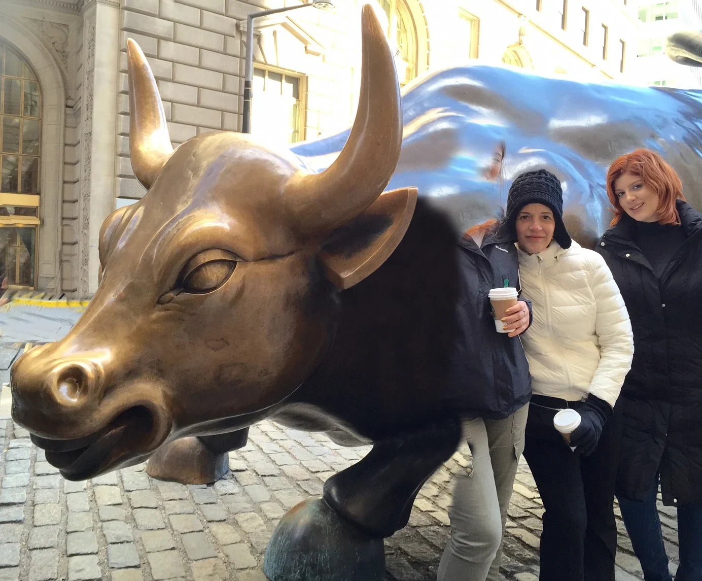 Friends posing with the Charging Bull of Wall Street
