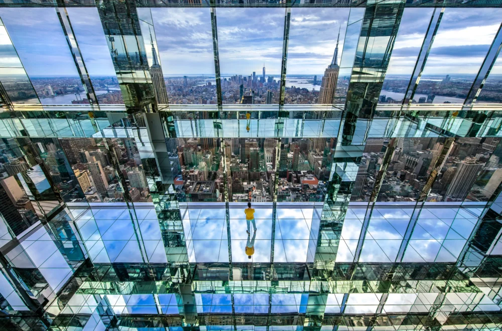 Person glooking at the view from the Summit One Vanderbilt in NYC