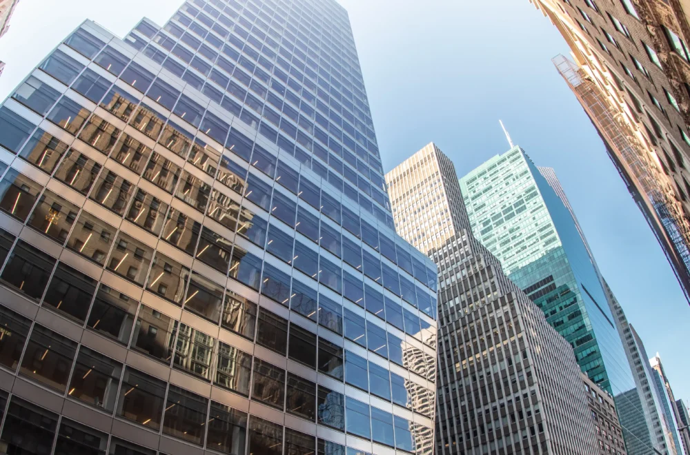 Wide angle upward view of Buildings and trees near Bryant Park in NYC